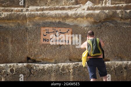 Touristique près du signe de 'pas d'escalade' au pied de la grande pyramide de Cheops au Caire. Égypte Banque D'Images