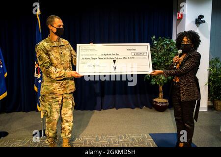 Le lieutenant-colonel John Francis, 61e groupe de base aérienne IMA au commandant adjoint et Mme Cathy Howard, chef de vol, Airman et état de préparation de la famille, Présentez un chèque de « réduction des coûts » de 536,247 $ à la base aérienne de Los Angeles, qui représente les 19,000 heures de bénévolat que ces personnes ont données à la base lors de la cérémonie d’appréciation des bénévoles de la base aérienne de Los Angeles. Banque D'Images