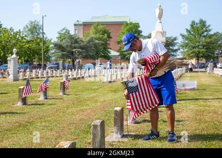 Activité de soutien naval Hampton Roads Portsmouth Directeur du site Kenneth Pugh place des drapeaux sur les tombes des membres du service déchus lors de la cérémonie annuelle de placement du drapeau au cimetière naval commémoratif du Capitaine Ted Conaway, au Centre médical naval de Portsmouth (PNLP), le 27 mai. Banque D'Images