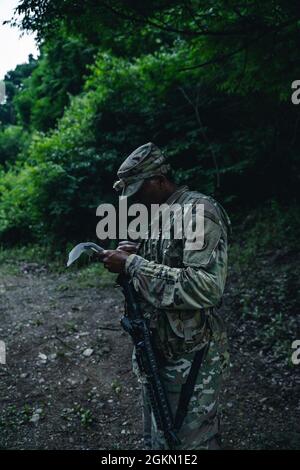 Sgt. Jamal Walker, musicien affecté à l'Armée des États-Unis au Japon, effectue la navigation terrestre pendant la compétition du meilleur guerrier du Pacifique de l'Armée des États-Unis 2021 à Camp Casey, Corée du Sud, le 3 juin 2021. Le BWC USARPAC 2021 est un concours annuel d'une semaine qui se compose de concurrents de plusieurs unités USARPAC. Cette année, en raison de la COVID-19, la compétition aura lieu dans toute l'Indo-Pacific, avec des concurrents menant des événements physiques à leur station d'accueil et participant à un comité de connaissances virtuel présidé par le sergent de commandement de l'USARPAC Major. Les officiers non commissionnés et junior Banque D'Images