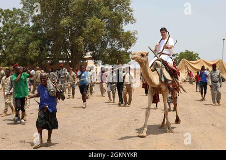 Le Maj. Steven Kornegay, de l'armée américaine, roule un chameau après sa promotion au complexe d'intervention du bataillon Rapide (BIR) à Djibouti, le 9 juin 2021. Kornegay a eu une cérémonie en robe traditionnelle avec des soldats BIR djiboutiens pour signifier l'unité entre les forces. Banque D'Images