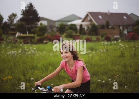 Petite fille à vélo dans la campagne, pays-Bas Banque D'Images