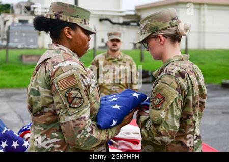 Des aviateurs de la U.S. Air Force de la Kadena Honor Guard effectuent une cérémonie de mise au rebut du drapeau à la base aérienne de Kadena, au Japon, le 14 juin 2021. Le jour du drapeau, le 14 juin, est recommandé comme le jour le plus approprié pour tenir cette cérémonie chaque année. Banque D'Images