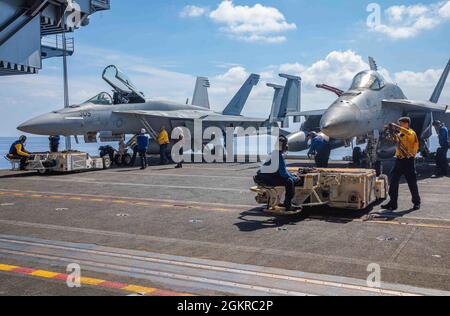 210619-N-NY362-1021 ANDAMAN SEA (le 19 juin 2021) les marins se préparent à déplacer les F/A-18E Super Hornets attachés à l’escadre aérienne Carrier 5 dans la baie hangar du seul porte-avions déployé par l’avant de la marine américaine USS Ronald Reagan (CVN 76). Ronald Reagan, le navire amiral du Carrier Strike Group 5, fournit une force prête au combat qui protège et défend les États-Unis, ainsi que les intérêts maritimes collectifs de ses alliés et partenaires dans la région Indo-Pacifique. Banque D'Images