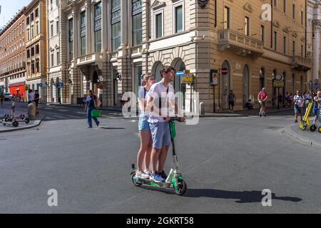 Rome, Italie - 26 août 2021 : deux garçons utilisent des scooters électriques pour se déplacer dans les rues du centre-ville. Banque D'Images