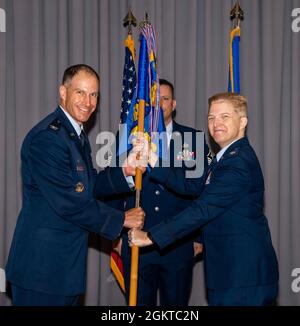 Le colonel Matt Husemann, à gauche, 436e commandant de l'escadre de transport aérien, passe le guide au lieutenant-colonel Gretchen Lewis lors d'une cérémonie de changement de commandement sur la base aérienne de Douvres, Delaware, le 28 juin 2021. La cérémonie a vu le Maj. Kevin Byram renoncer au commandement de Lewis. Banque D'Images