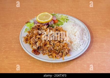 Menu plat de kebab mélangé garni de riz basmati et salade avec oignon rouge et tomate citron pour l'assaisonnement Banque D'Images