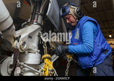 OCÉAN PACIFIQUE (2 juillet 2021) le compagnon d’Aviatien Boatswain (Handling) Shila Souza, de Wahaiwai, Hawaii, chaîne un Super Hornet FA-18e affecté aux “vigilantes” du Strike Fighter Squadron (VFA) 151 dans la baie hangar à bord du porte-avions USS Abraham Lincoln (CVN 72). Abraham Lincoln mène actuellement des opérations de routine dans la zone d'exploitation de la 3e flotte américaine. Banque D'Images