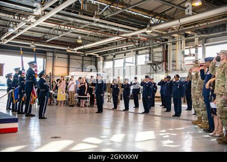 Les aviateurs de la 501e Escadre de soutien au combat et les invités saluent lors de la lecture de l'hymne national à la RAF Alconbury, en Angleterre, le 20 juillet 2021. La cérémonie est une tradition militaire qui représente un transfert officiel de l’autorité et de la responsabilité d’une unité d’un commandant à un autre. Banque D'Images