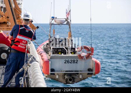 CAPE COD, Ma -- (le 24 juin 2021) le chef Boatswain’s Mate Emmons, le chef du département de pont affecté à la Cutter d'endurance moyenne blanche USCGC Escanaba, observe le bateau de classe 26282 de l'horizon s'abaisser dans l'eau pour des exercices OTH. Des exercices OTH sont nécessaires pour la préparation des patrouilles maritimes. Banque D'Images