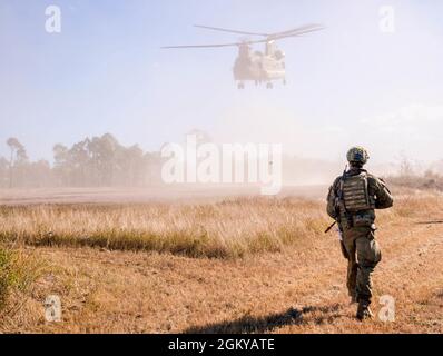 Un soldat de l'armée australienne du 1er Bataillon, Royal Australian Regiment, assure la sécurité tandis qu'un Chinook de l'armée australienne CH-47 part avant un entraînement combiné d'assaut urbain à l'exercice Talisman Sabre 21 dans la zone d'entraînement de Townsville Field, Queensland, Australie, le 28 juillet 2021. TS21 soutient la stratégie de défense nationale des États-Unis en améliorant la capacité de protéger la patrie et de fournir des forces crédibles au combat pour répondre à toute la gamme des préoccupations potentielles en matière de sécurité dans l'Indo-Pacifique. Banque D'Images