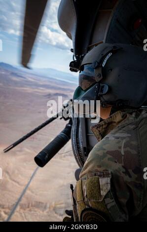 Tech. Sgt. Derrick Schwenk, aviateur de missions spéciales d'instructeur avancé du 34e Escadron d'armes (SPSF), instruit l'équipage lors de l'entraînement de manoeuvre de combat aérien (ACM), dans un HH-60G Pave Hawk près de la base aérienne de Nellis, Nevada, le 28 juillet 2021. Le 34e WPS offre une formation de combat inégalée et permet aux étudiants de mener des combattants contre des adversaires proches de la poire en tant qu'experts tactiques dans la communauté HH-60G. Banque D'Images