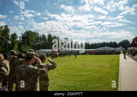 Les élèves de la classe 08-21 du cours de base et les supporters de la 7e Académie des officiers non commissionnés de l'Armée saluent le drapeau pendant que l'hymne national est joué pendant la cérémonie de remise des diplômes de la NCOA, le 30 juillet 2021, au Camp Aachen, en Allemagne. La 7e mission de l’AOC de l’Armée de terre consiste à former et à former de futurs leaders qui sont adaptatifs, disciplinés et prêts à diriger efficacement au niveau de l’équipe et de l’équipe. Banque D'Images