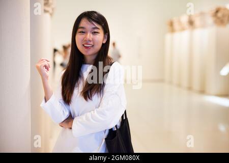 Fille chinoise réfléchie dans le musée regardant l'objet d'art d'antiquité Banque D'Images