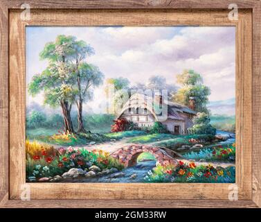 Peinture à l'huile dans un cadre en bois représentant un cottage idyllique près d'une crique avec des fleurs sauvages colorées et un pont en pierre. Banque D'Images