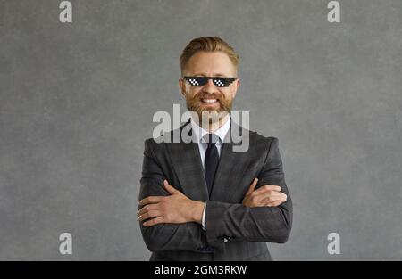 Homme d'affaires adulte portant un costume, une cravate et des lunettes de vie amusantes Banque D'Images