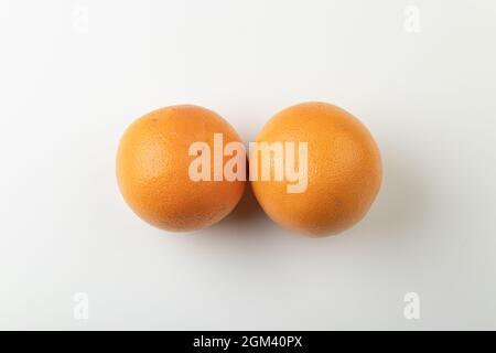 Deux pamplemousses d'orange entiers isolés sur fond blanc, vue de dessus Banque D'Images