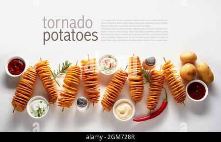 Vue de dessus de pommes de terre tornado frites délicieuses sur brochettes servies avec des sauces et épices assorties avec des herbes vertes et du piment rouge sur fond blanc W Banque D'Images