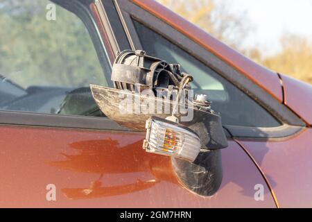 Rétroviseur latéral cassé sur une voiture sale. Rétroviseur extérieur droit endommagé en gros plan Banque D'Images