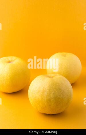 Orange aigre ou orange amère, également appelé séville, bigade ou orange marmelade, fruit d'agrumes à forte vitamine C isolé sur un fond jaune vif Banque D'Images