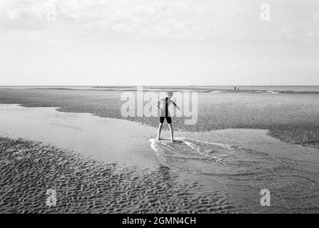 Un jeune garçon de 12 ans arnaque à West Wittering Beach, Chichester, West Sussex, Angleterre, Royaume-Uni, Angleterre, Royaume-Uni. Banque D'Images