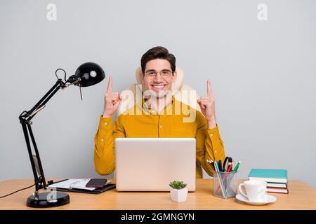 Portrait d'un programmeur d'homme gai attrayant pointant vers le haut copie espace vide isolé sur fond gris couleur Banque D'Images