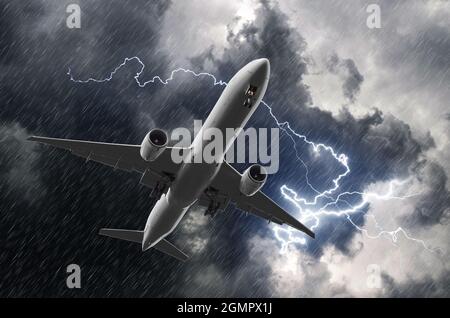 Atterrissage d'un avion de passagers blanc pendant un orage de pluie, mauvais temps Banque D'Images