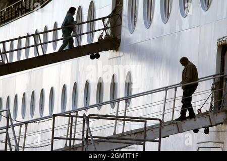 Ketchikan, Alaska, États-Unis - 26 mai 2010; silhouetted les gens en vue. Ici, nous voyons des passagers s'embarquer et débarquer pendant qu'un paquebot de croisière est amarré Banque D'Images