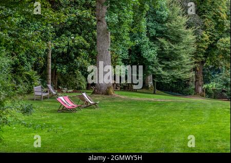 Un peu de repos et de détente sur les transats installés dans un jardin somptueux Banque D'Images