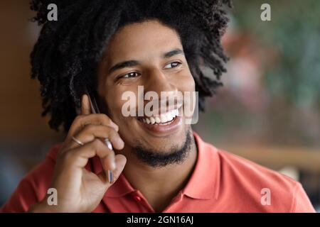 Appel mobile. Gros plan de jeune homme noir gai parlant sur téléphone portable Banque D'Images