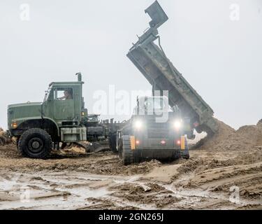 Les Seabees affectés au bataillon de construction mobile navale (NMCB) 133 aident à défricher les routes pendant les secours en cas de catastrophe de l'ouragan Ida à Grand Isle, Le NMCB 133 travaille aux côtés de ses services homologues en tant que seul élément de la Marine à soutenir le soutien de la Défense des autorités civiles (DSCA) pour soutenir les efforts de secours en cas de catastrophe de la Garde nationale de Louisiane. La mission du NMCB 133 est de fournir une force navale adaptative et évolutive en tant que composante essentielle de la stratégie maritime des États-Unis dans l'exécution de la construction de qualité dans les opérations de combat, d'aide humanitaire ou de reprise après sinistre. Banque D'Images
