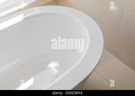 Salle de bain blanche et pure avec baignoire séparée.Salle de bains avec grandes fenêtres Banque D'Images