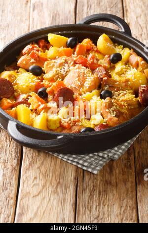 Chinois Galinha un ragoût de poulet Portuguesa avec des légumes dans le curry de noix de coco en gros plan dans une poêle sur la table. Verticale Banque D'Images