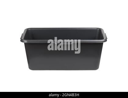Un contenant en plastique noir utilisé sur un chantier de construction ou pendant la rénovation pour mélanger le plâtre ou le mortier. Récipient rectangulaire en plastique noir i Banque D'Images