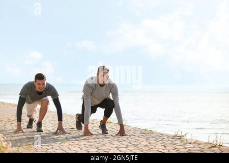 Les jeunes hommes sportifs se prépare à courir près de la rivière Banque D'Images