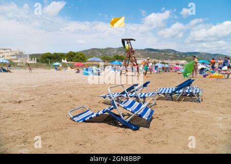 ALCOSSEBRE, ESPAGNE - 22 septembre 2021 : Communauté Valencienne, Espagne - août 2021. Vider les chaises longues en plastique blanc et bleu sur la plage. Vacances à la plage avec Banque D'Images