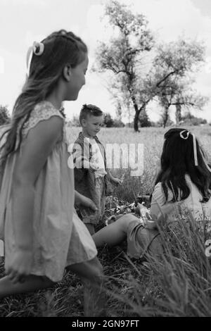 Famille dans l'herbe. Photo en noir et blanc Banque D'Images