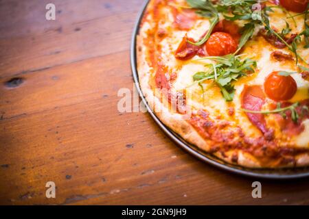 Gros plan d'une pizza sur une table en bois, avec espace de copie. Banque D'Images