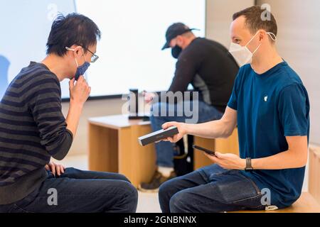 Londres, Royaume-Uni. 24 septembre 2021. Un personnel Apple a vu remettre à un client sa copie de l'iPhone 13. Apple a sorti l'iPhone 13 le 24 septembre 2021. Les clients ont été vus en visite dans le magasin phare de Regent Street London pour faire un achat et pour essayer diverses nouvelles fonctionnalités du téléphone en magasin. Crédit : SOPA Images Limited/Alamy Live News Banque D'Images