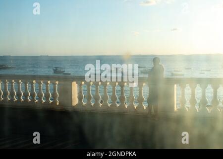 Salvador, Bahia, Brésil - 17 juin 2021 ; balustrade de la plage de Porto da Barra vue à travers le verre sale de l'arrêt de bus. Banque D'Images