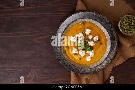 Soupe traditionnelle de purée de potiron avec fromage feta, graines, épices et basilic Banque D'Images