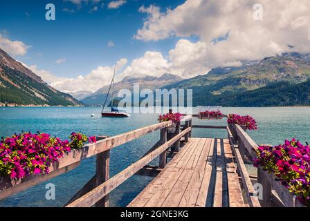 Jetée en bois sur le lac Sils avec yacht. Vue matinale colorée dans les Alpes suisses, col de Maloja, haute Engadine dans le canton des Grisons, Suisse, Europ Banque D'Images