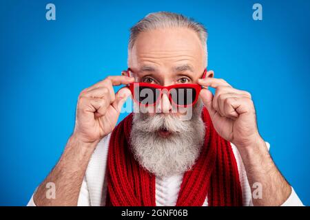 Photo de l'âge assez impressionné gentleman porter blanc chandail bras rouge oculaire grands yeux isolé couleur bleu fond Banque D'Images