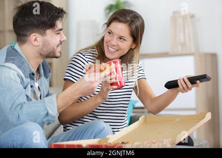 couple de repas à emporter et à l'aide de la télécommande Banque D'Images