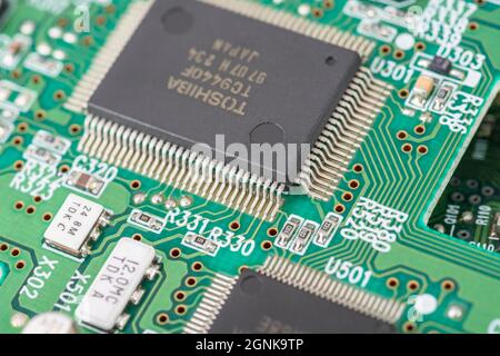 Pattes en M / brochages du circuit intégré / semi-conducteur IC Toshiba sur carte de circuit imprimé verte. Pour la technologie électronique, pénurie mondiale de puces Banque D'Images