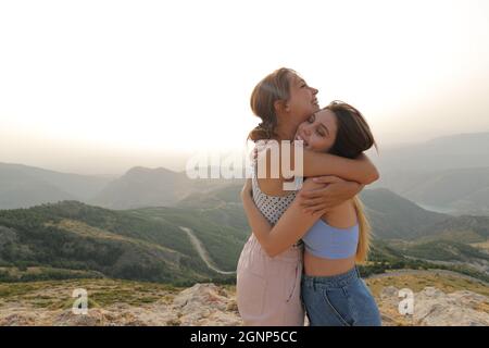 Deux heureux amis s'embrassant affectueux dans la nature pendant les vacances Banque D'Images