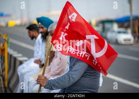 Ghaziabad, Inde. 27 septembre 2021. Un agriculteur détient un drapeau lors d'une grève nationale contre les réformes agricoles à la frontière entre Delhi et l'Uttar Pradesh.des milliers d'agriculteurs indiens ont bloqué la circulation sur les routes principales et les lignes de chemin de fer à plusieurs endroits du matin à l'occasion de la fermeture du Samyukta Kisan Morcha (Farmer Union Body), un corps de parapluie de 40 syndicats d'agriculteurs a commencé, le blocus a été levé à 4 heures. Crédit : SOPA Images Limited/Alamy Live News Banque D'Images