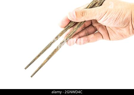 Baguettes en bois à la main isolées sur fond blanc Banque D'Images