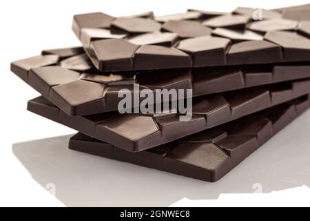 Pile de barres de chocolat noir brut sur fond blanc. Isoler. Banque D'Images