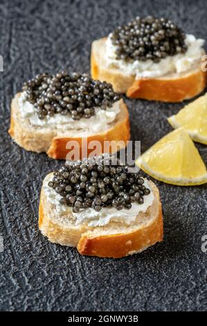 Tranches de baguette au fromage à la crème et au caviar noir Banque D'Images